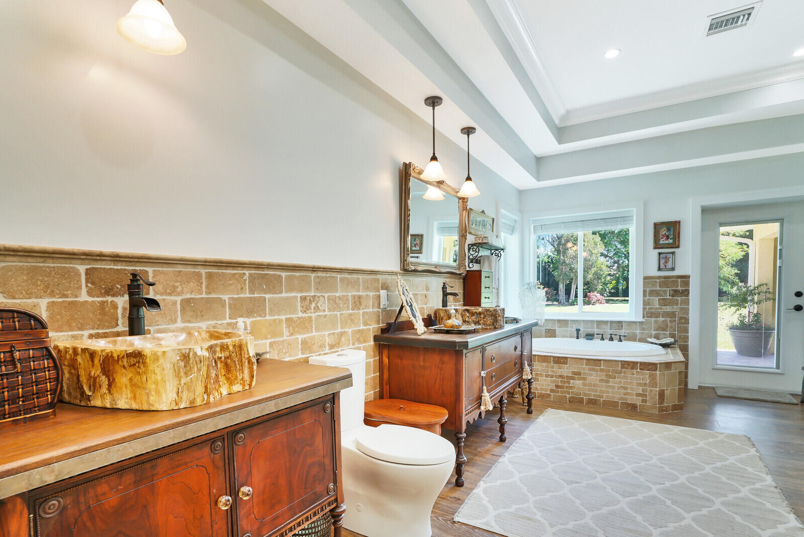 6624 Dillman Road Greenacres, FL 33413 - Photo 26 of 65 a bathroom with a granite countertop toilet a sink and a bathtub