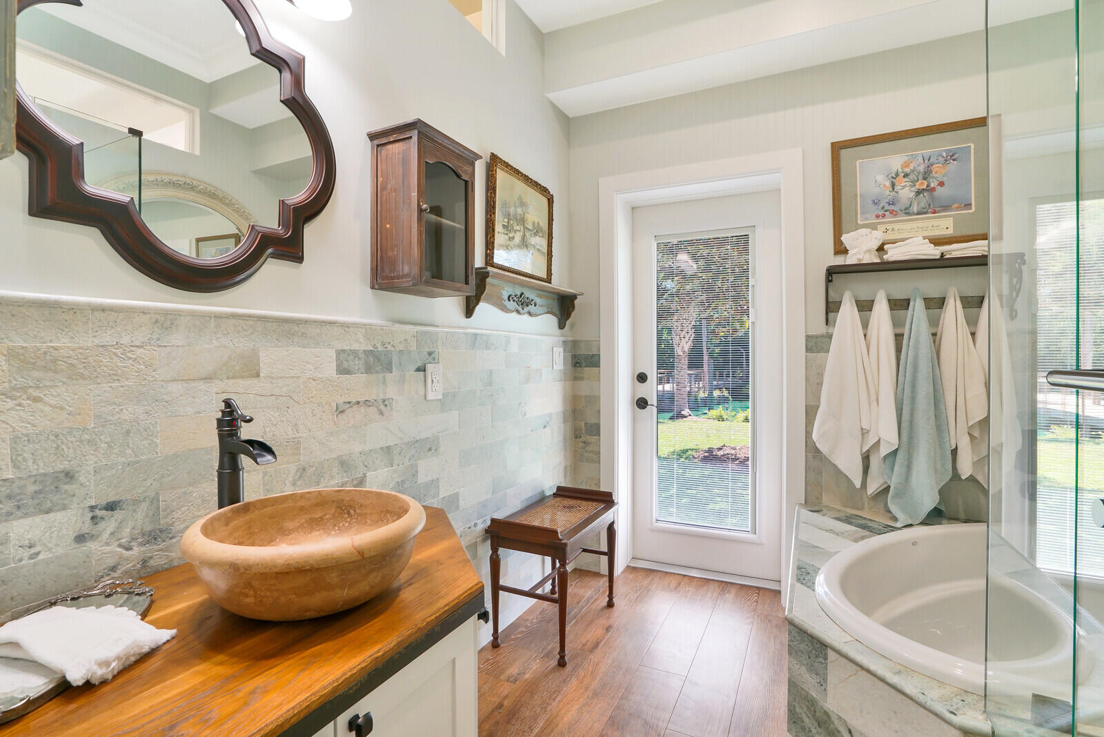 6624 Dillman Road Greenacres, FL 33413 - Photo 28 of 65 a bathroom with a tub and a wooden floor