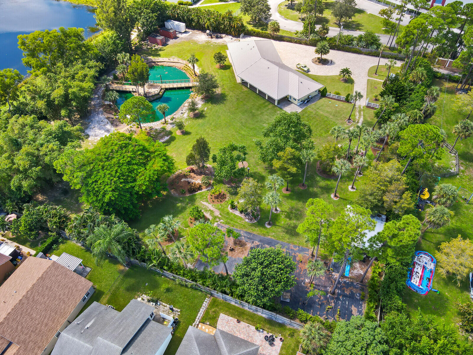 6624 Dillman Road Greenacres, FL 33413 - Photo 54 of 65 an aerial view of residential house with outdoor space and trees all around