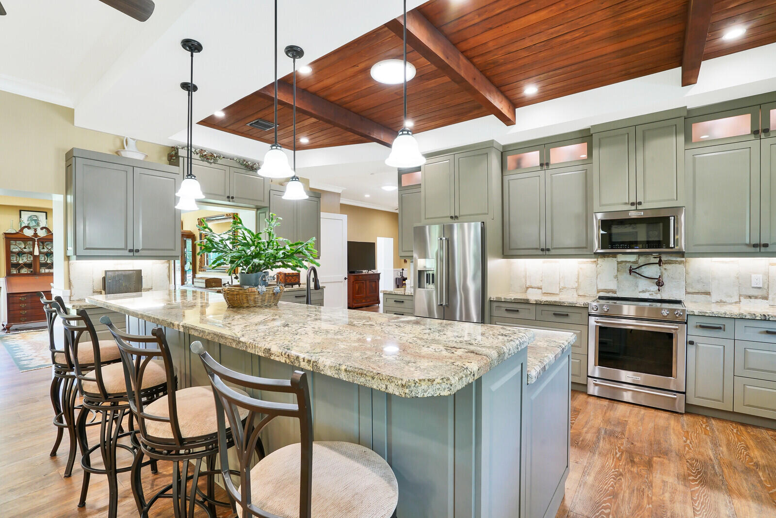 6624 Dillman Road Greenacres, FL 33413 - Photo 6 of 65 a kitchen with stainless steel appliances granite countertop a stove sink and cabinets