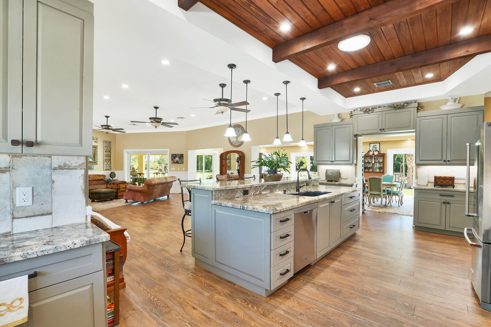 6624 Dillman Road Greenacres, FL 33413 - Photo 7 of 65 a kitchen with lots of counter top space and wooden floor