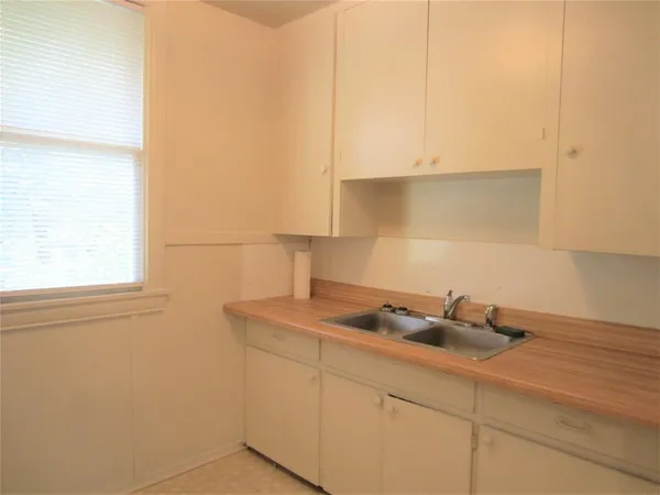 a kitchen with a sink cabinets and window