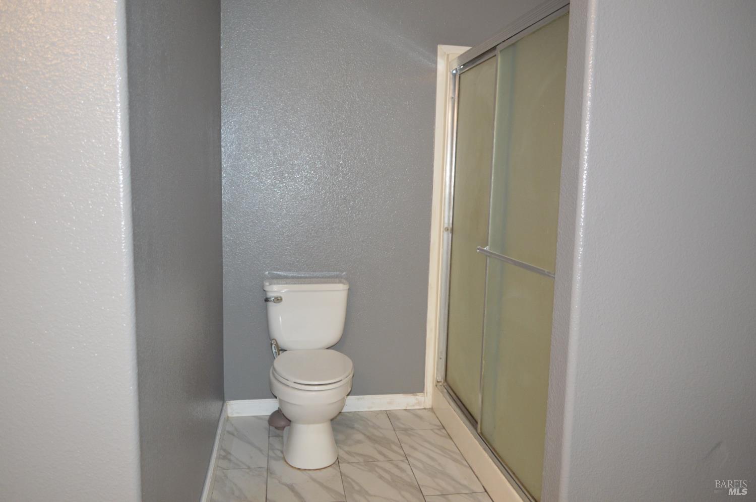 3900 North State Street, Unit 75 Ukiah, CA 95482 - Photo 13 of 22 a white toilet sitting next to a shower
