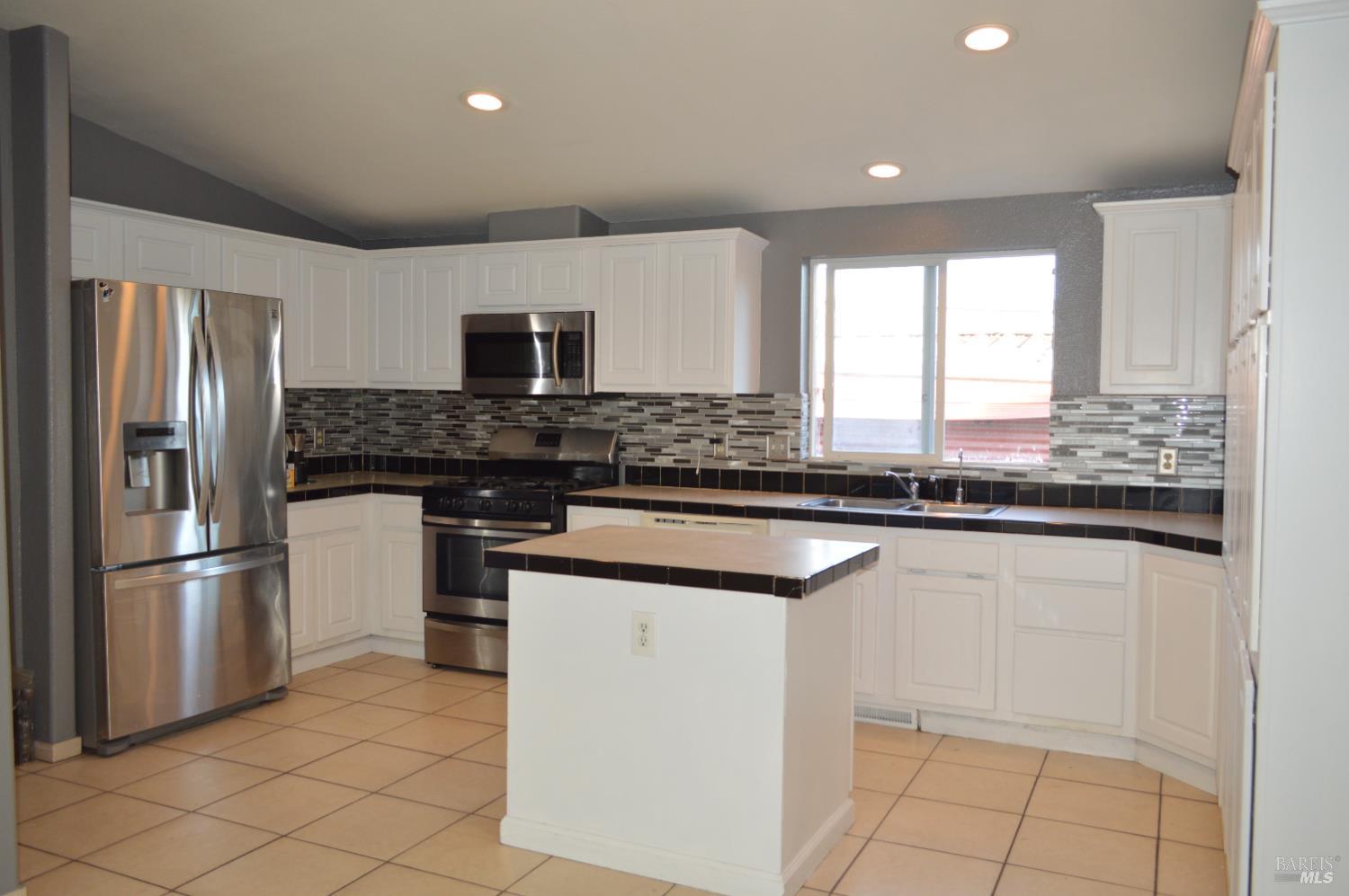 3900 North State Street, Unit 75 Ukiah, CA 95482 - Photo 2 of 22 a kitchen with stainless steel appliances granite countertop a stove a sink and a refrigerator