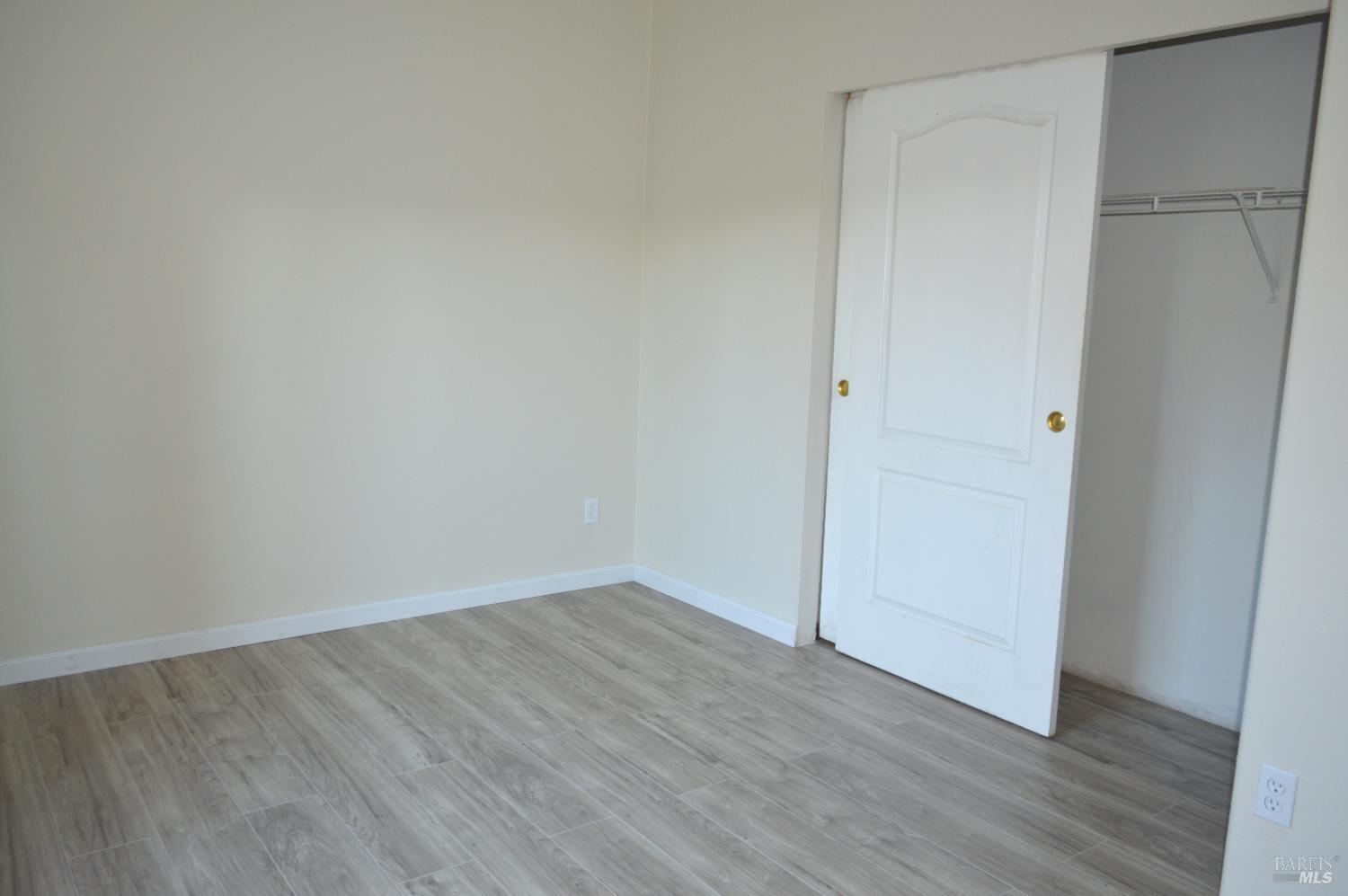 3900 North State Street, Unit 75 Ukiah, CA 95482 - Photo 21 of 22 a view of an empty room with wooden floor