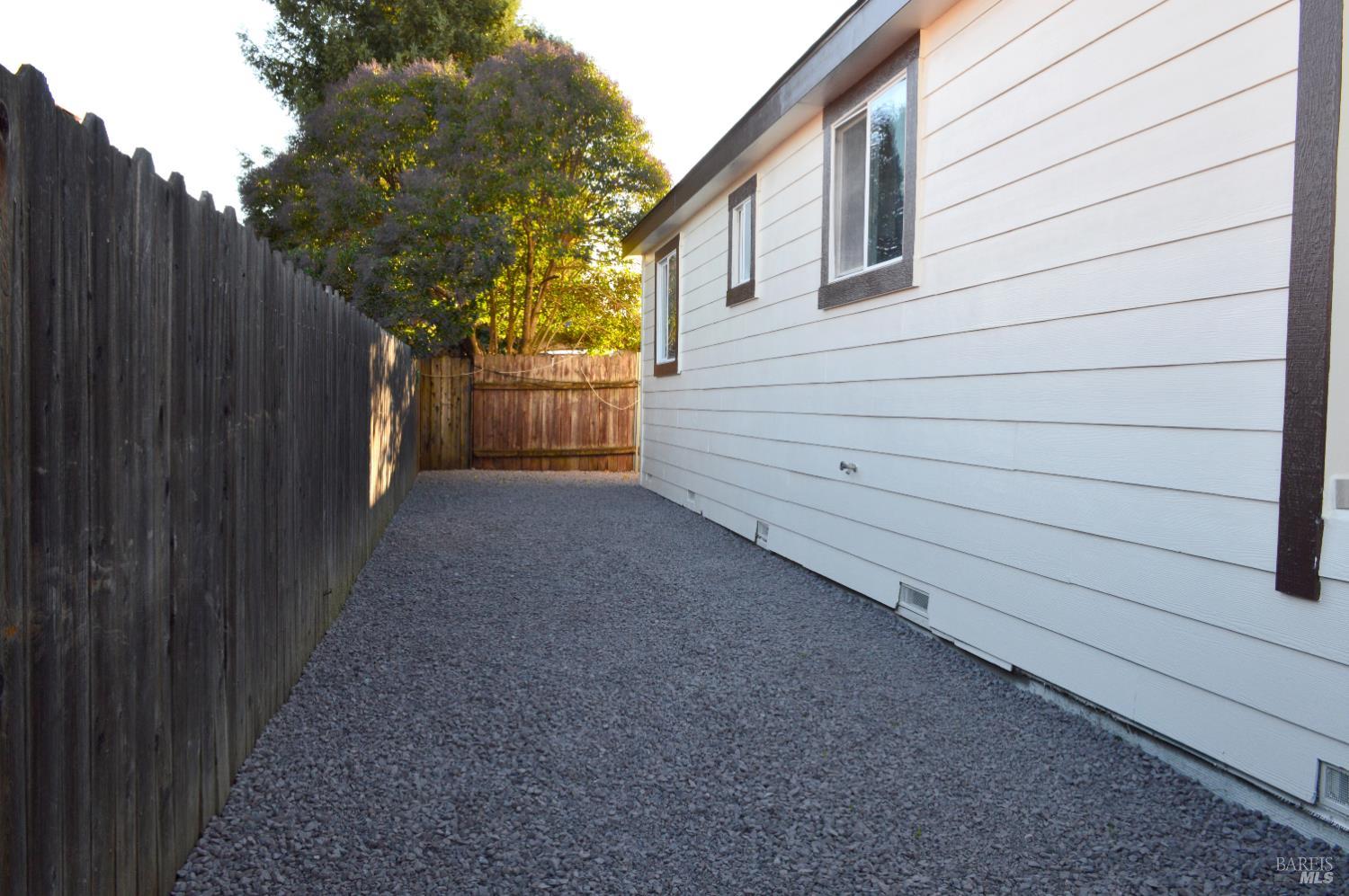 3900 North State Street, Unit 75 Ukiah, CA 95482 - Photo 22 of 22 a view of a house with backyard and wooden fence