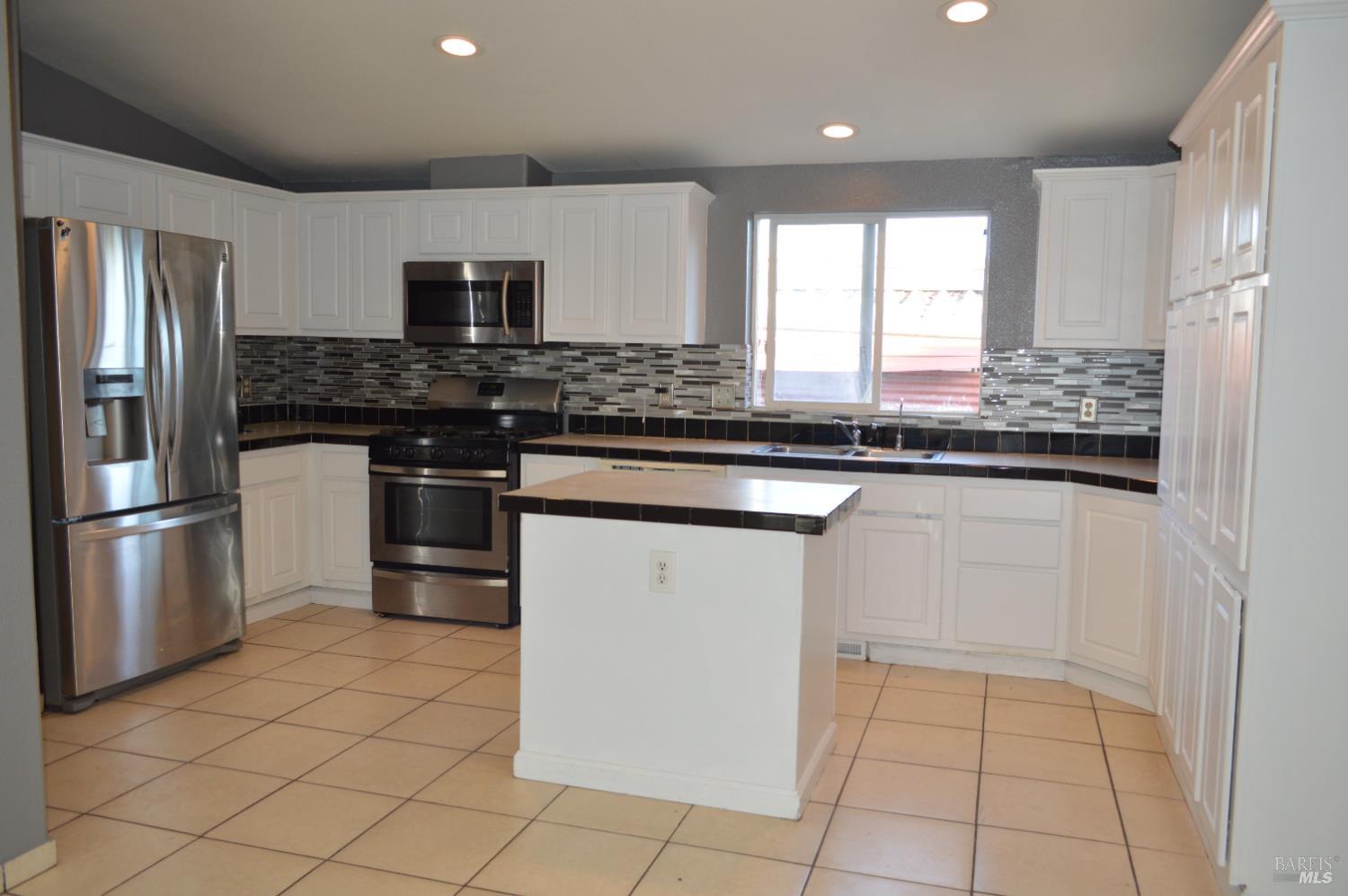 3900 North State Street, Unit 75 Ukiah, CA 95482 - Photo 3 of 22 a kitchen with stainless steel appliances granite countertop a stove a sink and a refrigerator