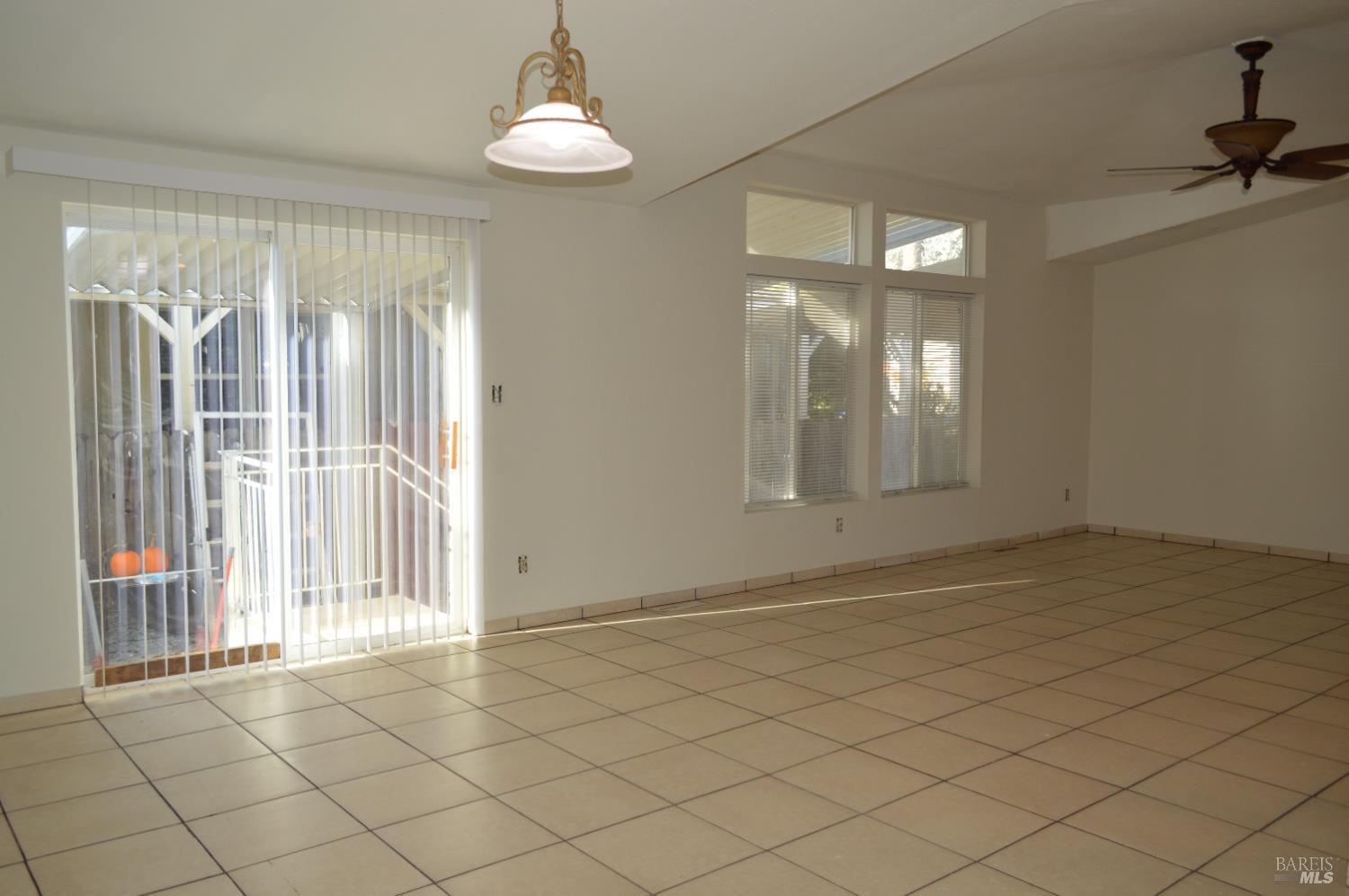 3900 North State Street, Unit 75 Ukiah, CA 95482 - Photo 8 of 22 an empty room with chandelier fan and windows