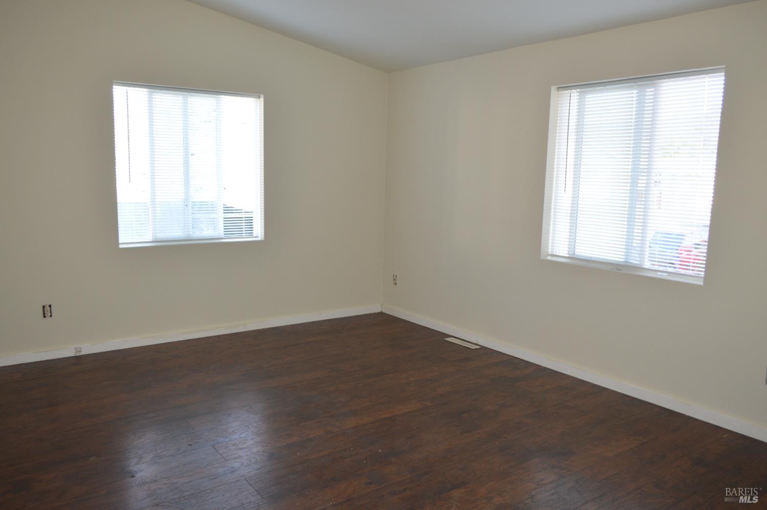 3900 North State Street, Unit 75 Ukiah, CA 95482 - Photo 10 of 22 an empty room with wooden floor and windows
