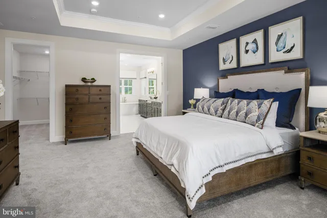 a spacious bedroom with a bed and a walk in closet