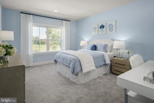 a spacious bedroom with a bed and a couch