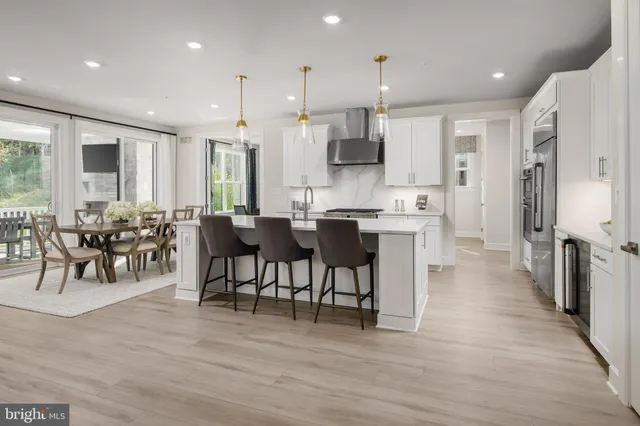 a view of a a dining area kitchen with furniture and stainless steel appliances