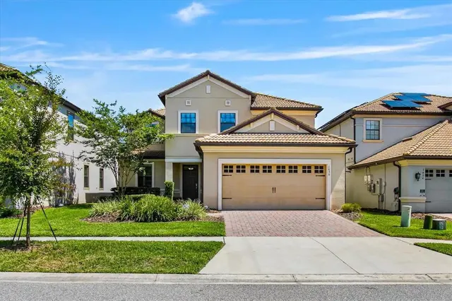 a front view of a house with a yard and garage