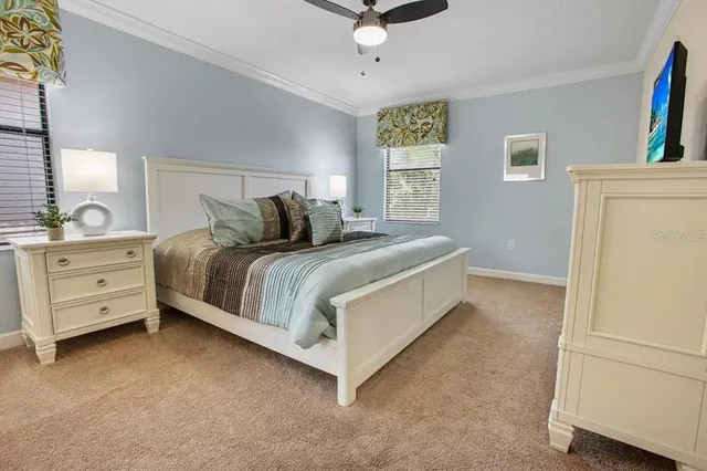 a bedroom with a bed and a refrigerator