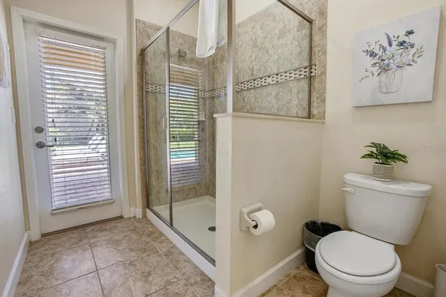 a bathroom with a toilet and a shower