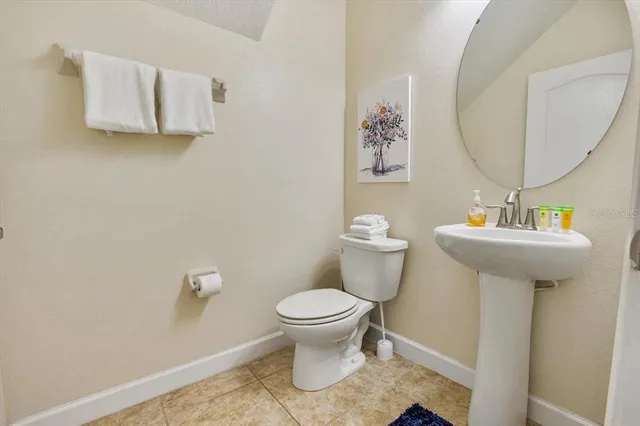 a bathroom with a sink toilet and a mirror