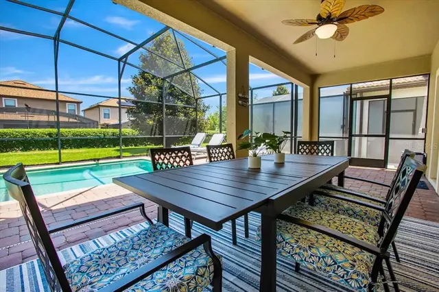 a view of a livingroom with furniture and a floor to ceiling window