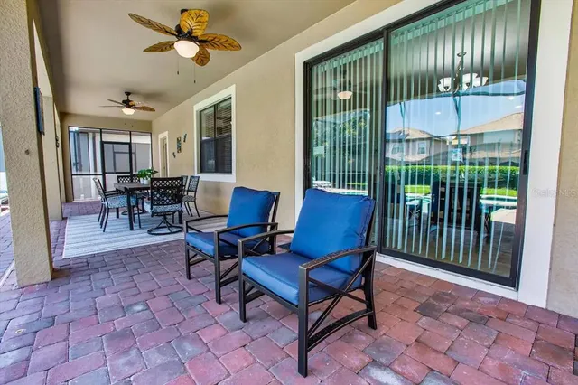 a view of sitting area with chairs and table in patio