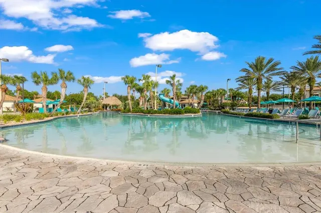 a view of swimming pool with a garden and seating area