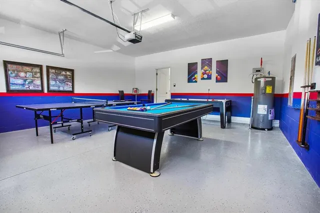 a room with stainless steel appliances dining table and chairs