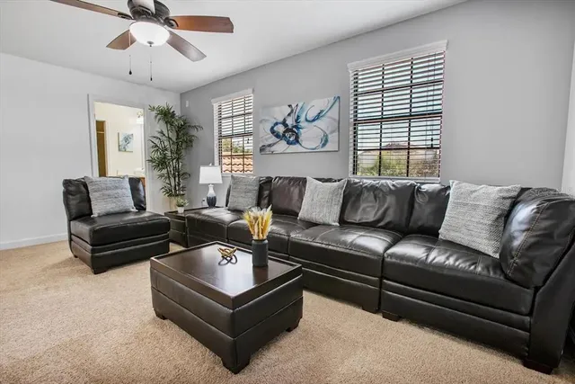 a living room with furniture and a large window