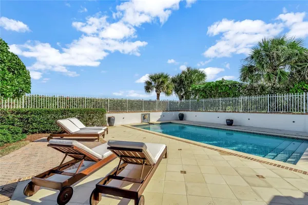 a view of a patio with furniture and garden
