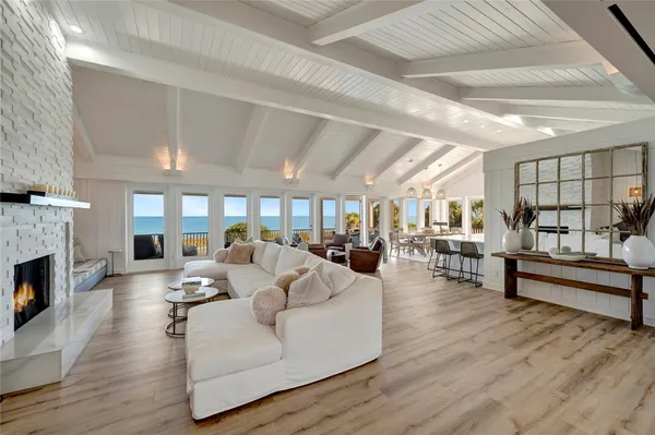 a living room with fireplace furniture and a wooden floor