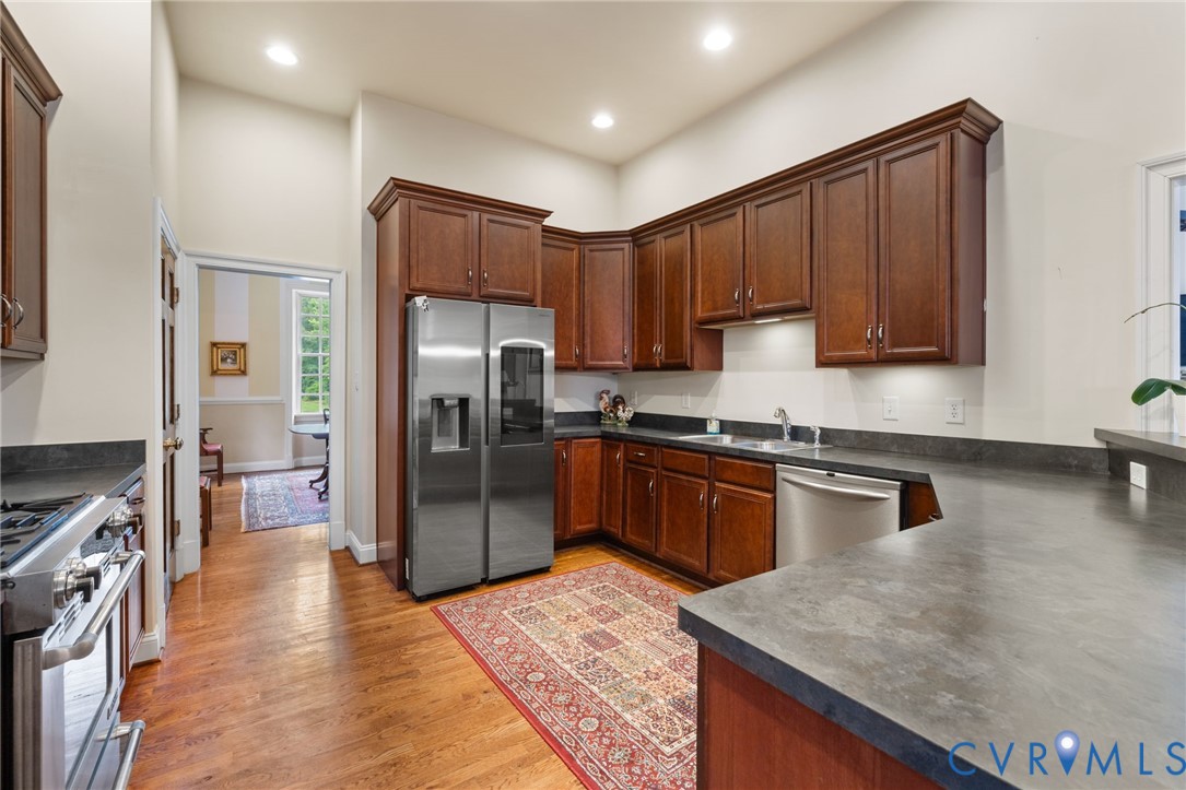 13173 Scotchtown Road Beaverdam, VA 23015 - Photo 23 of 65 a kitchen with granite countertop stainless steel appliances and wooden cabinets
