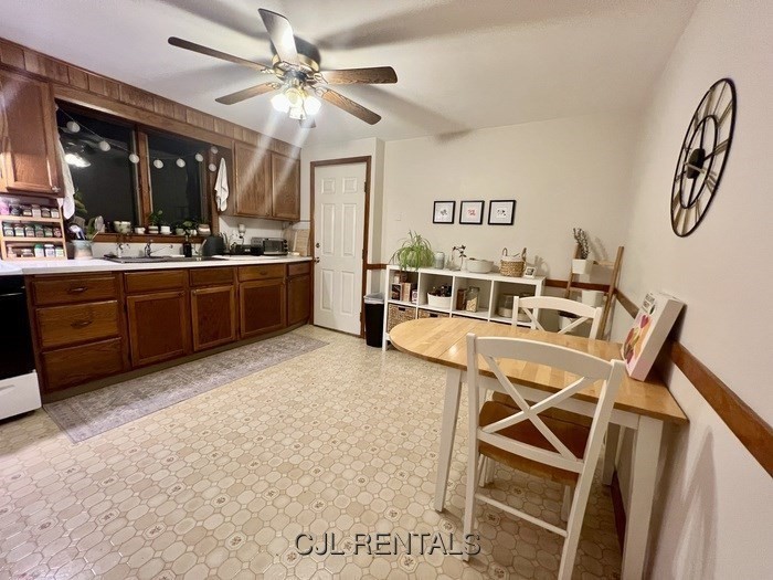 33 Evans Street, Unit 1 Watertown, MA 02472 - Photo 6 of 14 a living room with granite countertop furniture a ceiling fan and a wooden floor