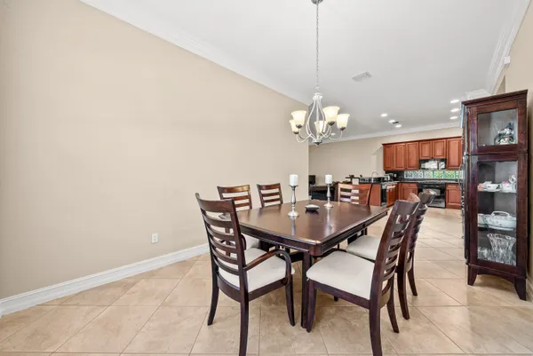 a view of a dining room with furniture and chandelier