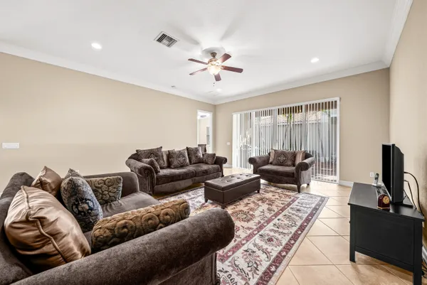 a living room with furniture ceiling fan and a rug