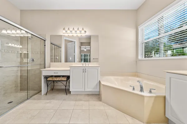 a large spacious bathroom with a bathtub shower and sink