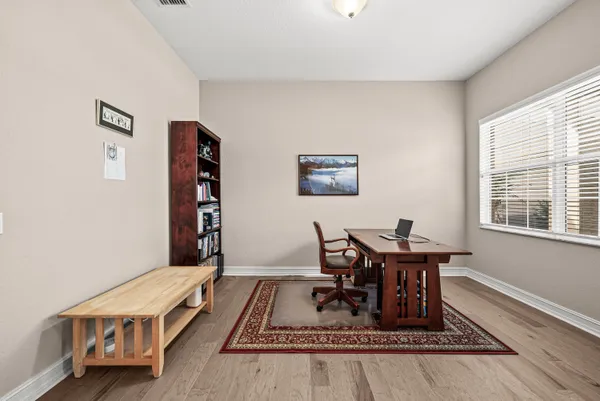 a living room with furniture a rug and a window