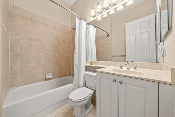 a bathroom with a sink a toilet and bathtub