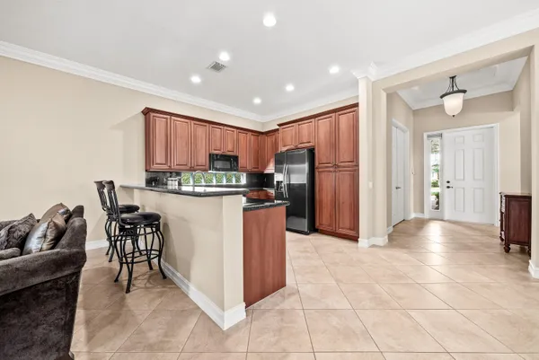 a kitchen with stainless steel appliances granite countertop a refrigerator and a stove top oven