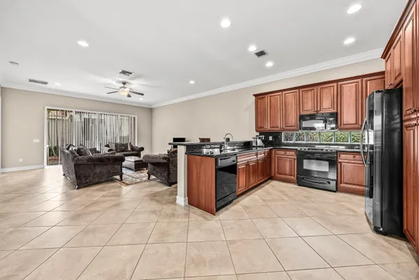 a kitchen with stainless steel appliances granite countertop a stove a sink a counter top space and cabinets