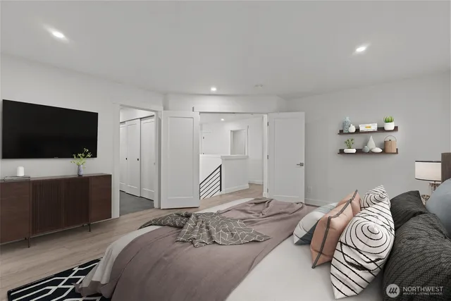 a bedroom with a bed and a flat screen tv