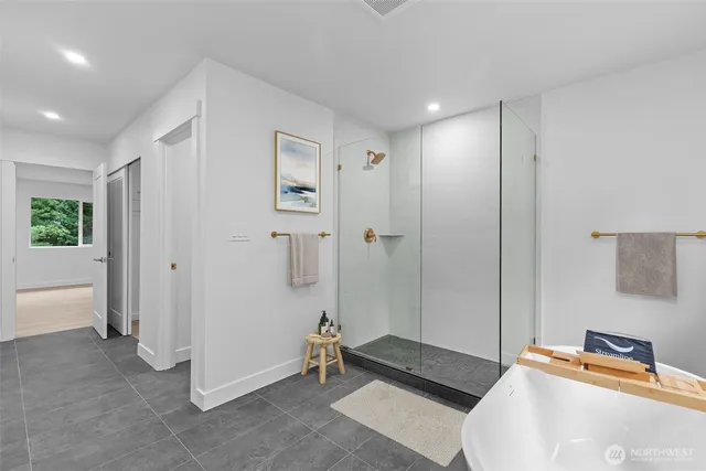 a bathroom with a bathtub and a shower