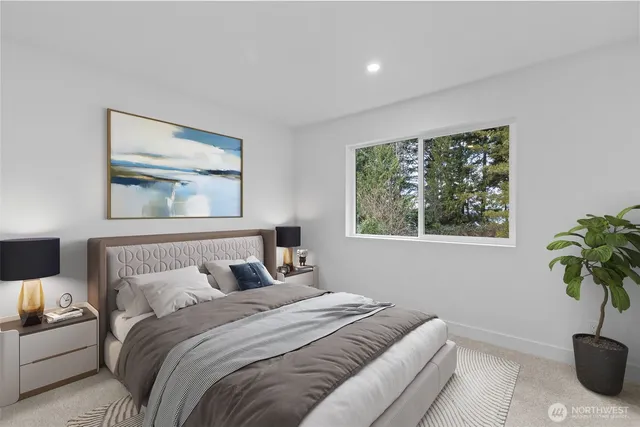 a bedroom with a bed and a potted plant