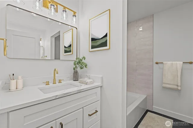a bathroom with a sink a mirror and a bathtub