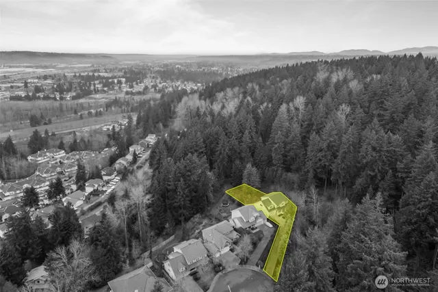 an aerial view of a house with a swimming pool