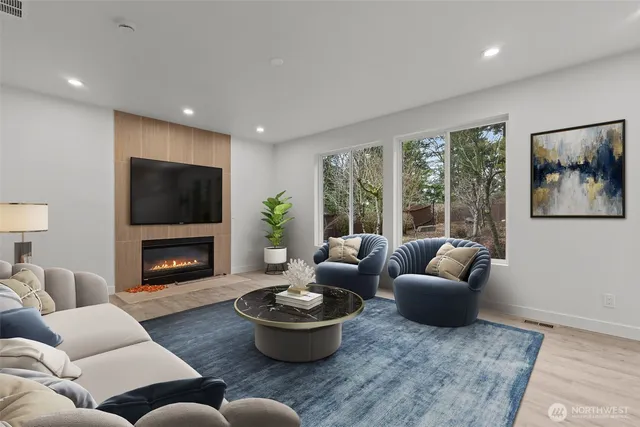 a living room with furniture a fireplace and a flat screen tv