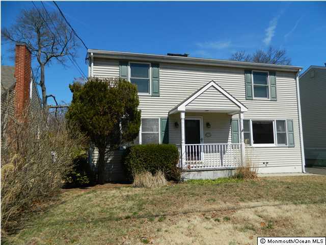 1138 Oak Road Manasquan, NJ 08736 - Photo 1 of 6 a view of a house with a yard