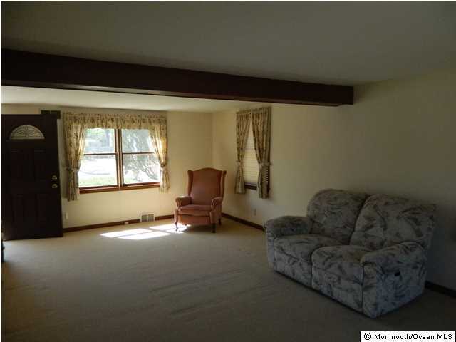 1138 Oak Road Manasquan, NJ 08736 - Photo 2 of 6 a living room with furniture and a window