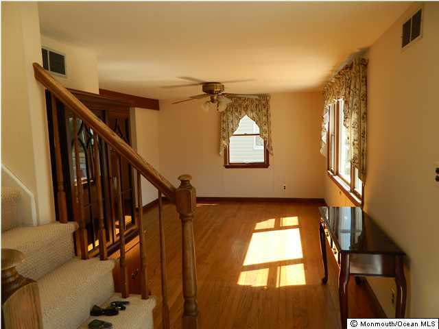 1138 Oak Road Manasquan, NJ 08736 - Photo 3 of 6 a view of entryway and hall with wooden floor