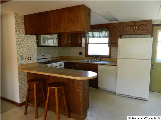 1138 Oak Road Manasquan, NJ 08736 - Photo 4 of 6 a kitchen with a sink and a refrigerator