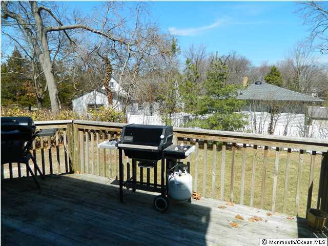 1138 Oak Road Manasquan, NJ 08736 - Photo 5 of 6 a view of a balcony with chairs and wooden floor