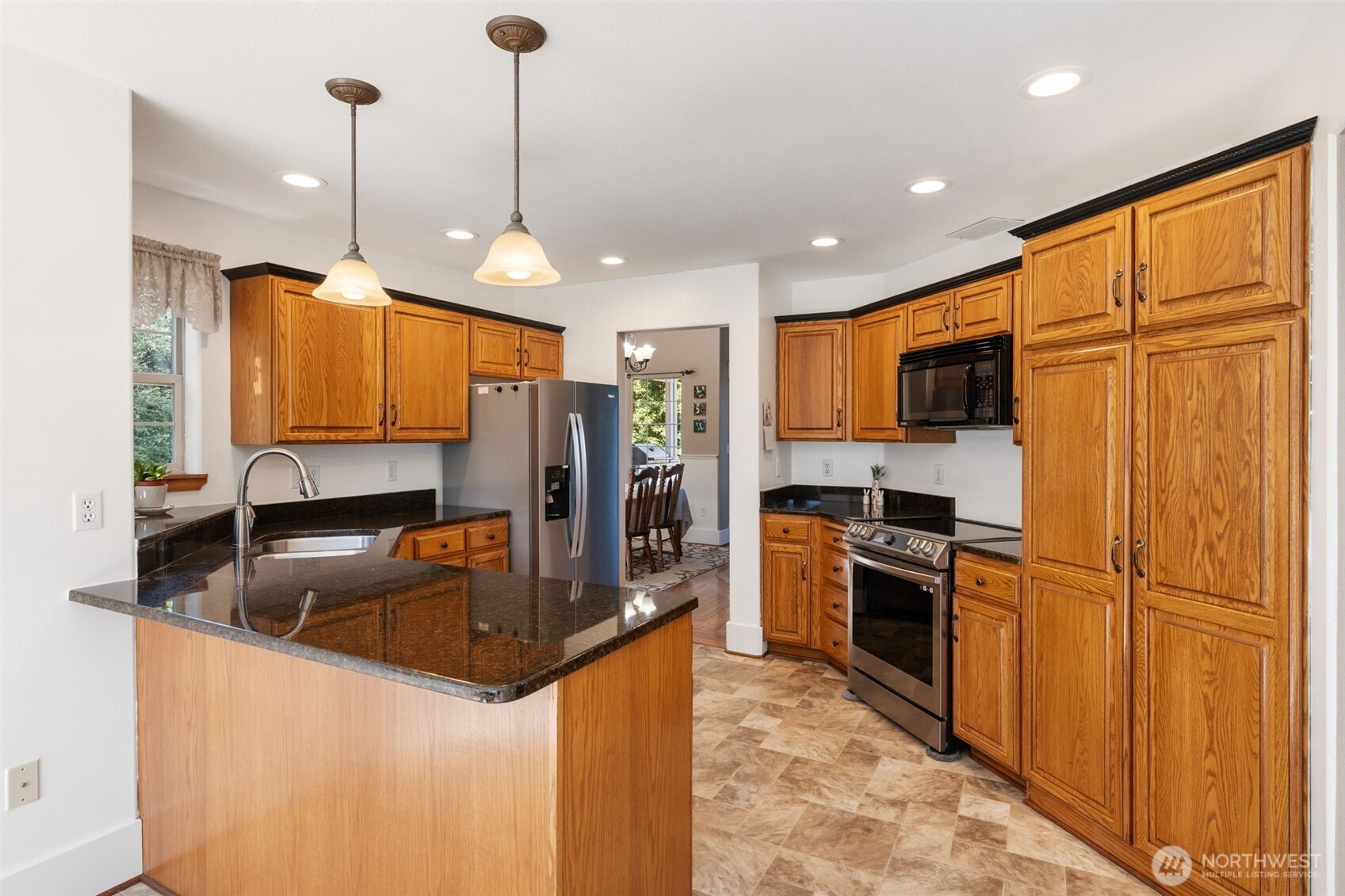 308 Brockway Road Chehalis, WA 98532 - Photo 12 of 40 a kitchen with granite countertop stainless steel appliances a refrigerator oven a sink a stove cabinets and wooden floor