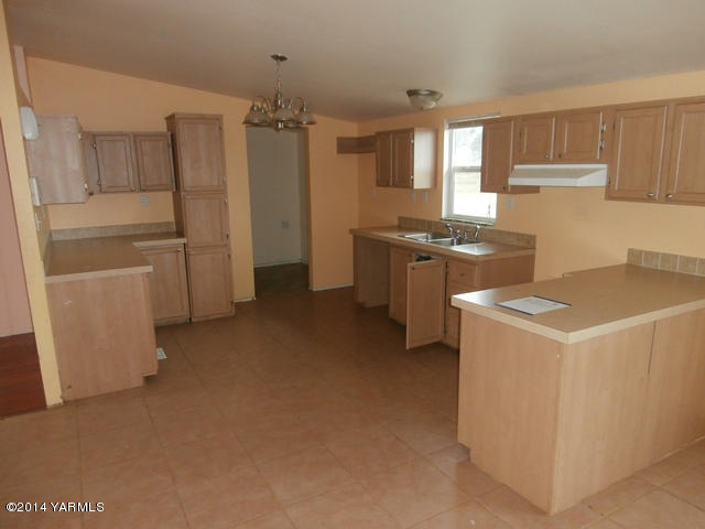 11305 Gilbert Road Yakima, WA 98903 - Photo 26 of 35 a kitchen that has a lot of cabinets and wooden floor