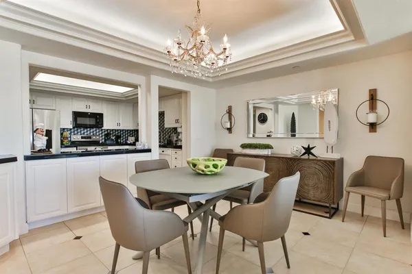 a view of a dining room with furniture and a chandelier